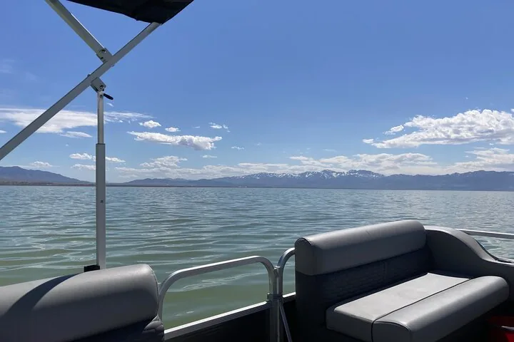 Pontoon boat view of the Great Salt Lake and distant mountains.