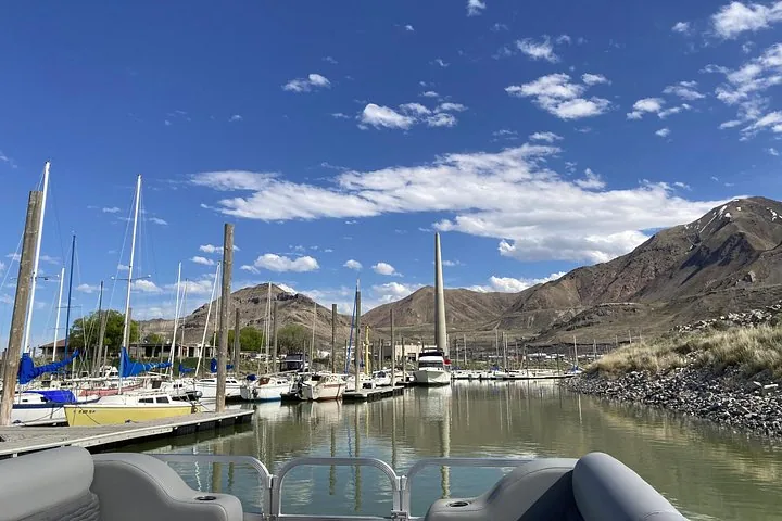 Marina view from a boat on Great Salt Lake with sailboats and mountains.